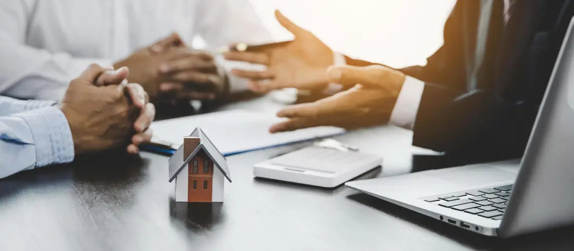 A property valuer and a real estate agent discussing property value