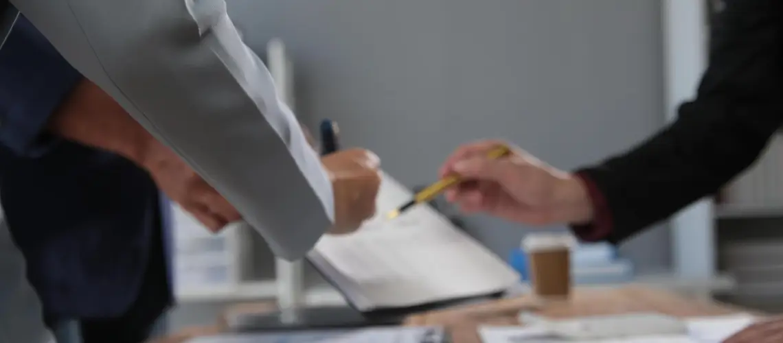 Certified Brisbane property valuer reviewing documents with a solicitor
